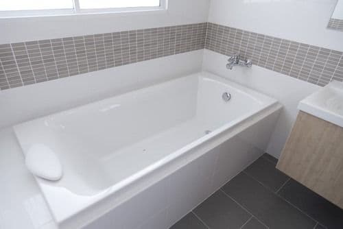 white tub with tile